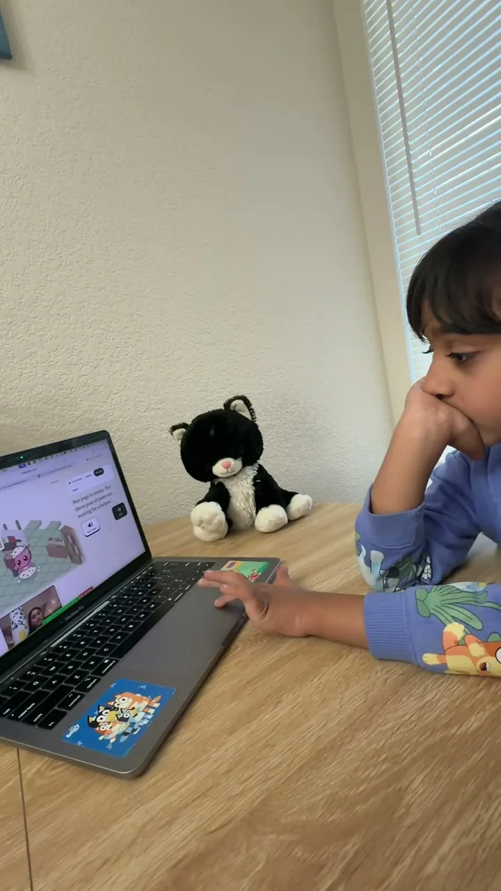 A child trying a mission on a laptop with their tutor on the call.
