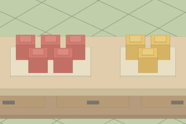 The math worktop, with five red blocks left on one tray and three yellow blocks moved aside onto another.